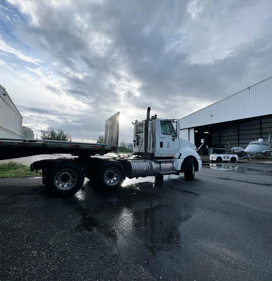 Prohaul flatbed truck at airport logistics facility