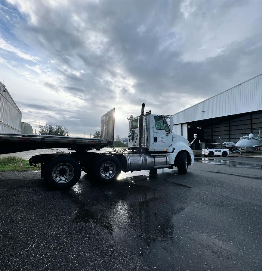 Prohaul red dump truck delivering asphalt